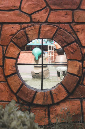 Window on brown brick wall texture backgroundの写真素材