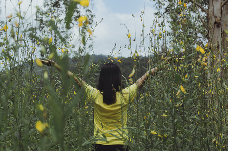 Beautiful portrait of young asain woman in yellow flowers garden,Outdoor.