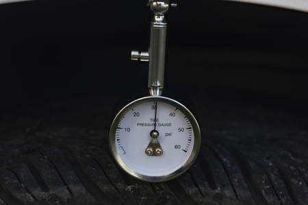 Auto mechanic pressure gauge for car tyre pressure measurement,Selective focus.の写真素材