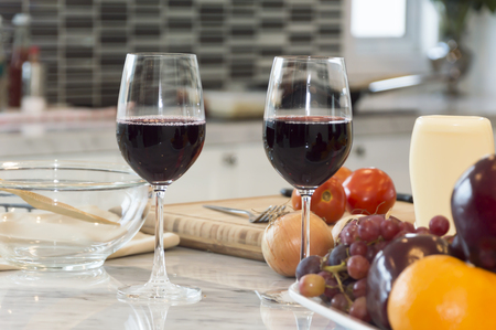 Fresh fruit, vegetable and red wine glass on the table