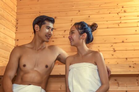 Beautiful couple relaxing in spa sauna room.の写真素材