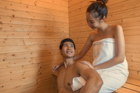 Beautiful couple relaxing in spa sauna room.の写真素材