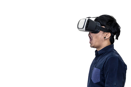 Man wearing virtual reality goggles. Studio shot, black background.