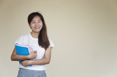 Beautiful woman of a student sitting with laptop and relaxing in the garden. Education concept.Copy space.の写真素材