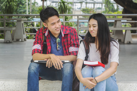 Tired student group with books sitting on the floor. Bored, tired and stressed to reading books for exams. exams and school concept . studying hard.の写真素材