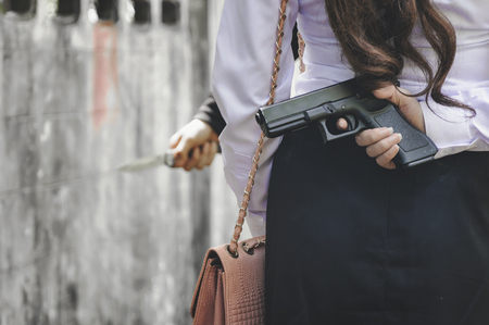 Office woman hiding gun safety self from robber thief mask danger with knife for stop gangster on...