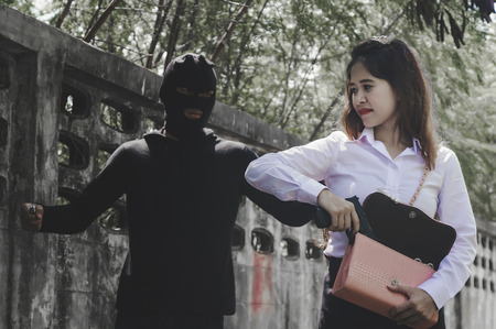 Office woman hiding gun safety self from robber thief mask danger with knife for stop gangster on...