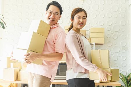 Young business couples startup family business, online marketing packaging and delivery scene. SME entrepreneur, Freelance work at home concepの写真素材