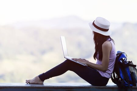Enjoying time at balcony. Beautiful young woman shopping online Happy in the morning.の写真素材