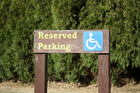 A Handicaped parking sign at  a park.の写真素材
