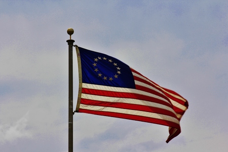 A US Flag flying with 13 stars, with blue sky and white clouds, that s bright and colorful in Kansas の写真素材