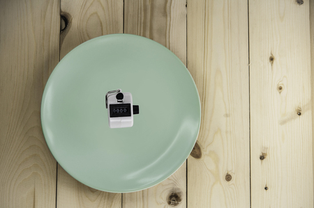 Cell count the counter is in a dish on a wooden floor の写真素材