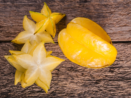 yellow star fruit or star apple on wood backgroundの写真素材