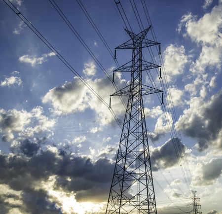 Sky high voltage pylon clouds.の写真素材