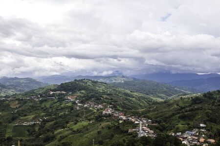 Mountains trees clouds cool weather.の写真素材