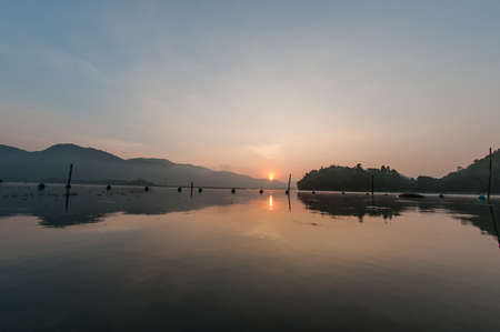 Backdrop wooden walkway lighting lake.の写真素材