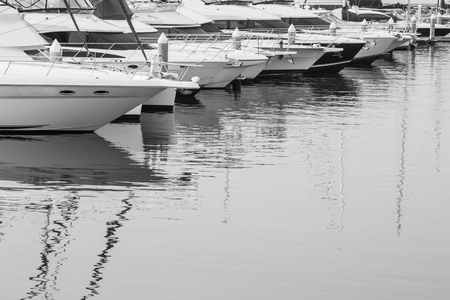 Many luxury yachts parked in a bay on the seaの写真素材