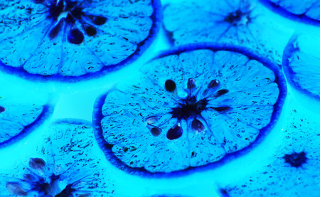 Blue, lime, lemon, cut into thin strips arranged in overlapping image is tinted blue image with photoshop.の写真素材