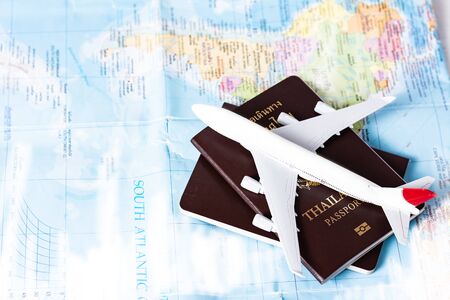 Model planes and thai passports for tourism on the world map.Travel planning concept on mapの写真素材
