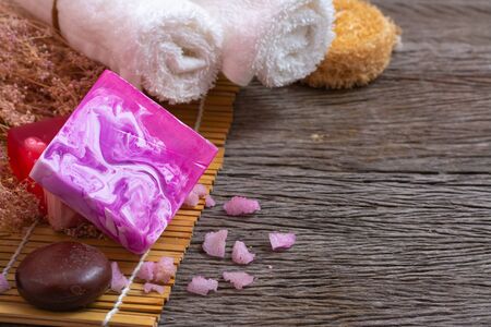 Bar of natural handmade soap with towel on wooden backgroundの写真素材