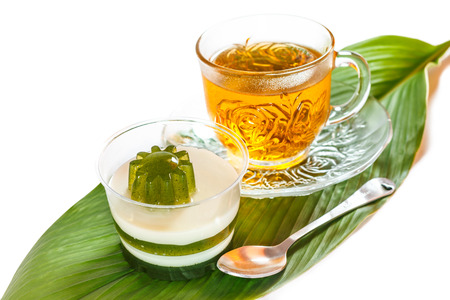 Pandan coconut and hot tea put on a green leaf. Eat to relieve hot cakes Thailand.