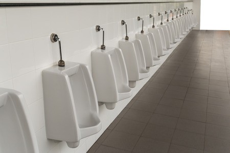 Urinals in the men's bathroom with white ceramic urinals design of white men in the toilet.の写真素材