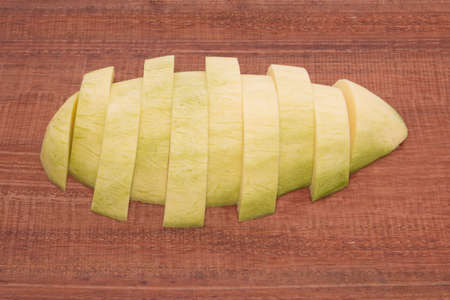 Fresh mango - Sliced green mangoes on wooden with isolated white background