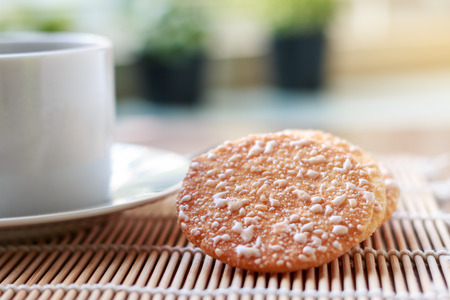 Crispy Rice Crackers with Hot cup of coffee on wooden table background.の写真素材