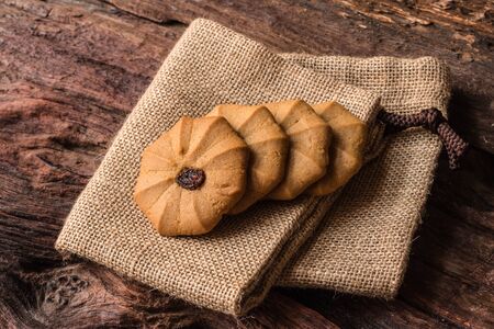 Cookies - Tasty cookies on brown cloth with rustic wooden table, Close upの写真素材