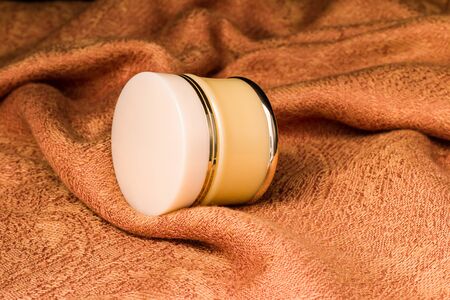 Cosmetics containers - Blank Cosmetic, Moisturizer containers for various makeup products on light brown cloth background, ready for your design product. の写真素材