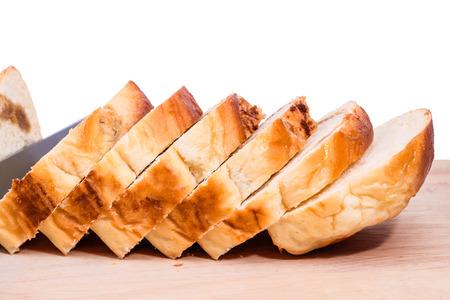 Bread slice - Homemade bread and slices of bread rustic on a wooden board with isolated on white background. Select focus.の写真素材