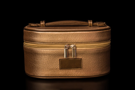 Cosmetics Bag - Golden brown cosmetics bag with soft shadows isolated on black background. The file includes a clipping path, so it's easy to work.の写真素材