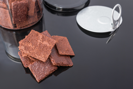 A stack of chocolate cookies on the dark background. Selective focus.の写真素材