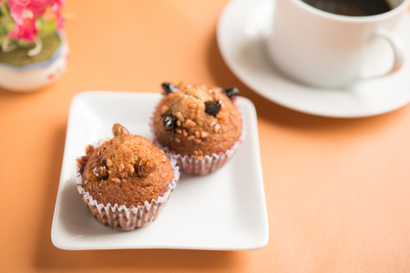 Insect food in a banana cupcake with black coffee in a white cup. Healthy meal high protein diet concept. Close-up, Selective focus.の写真素材