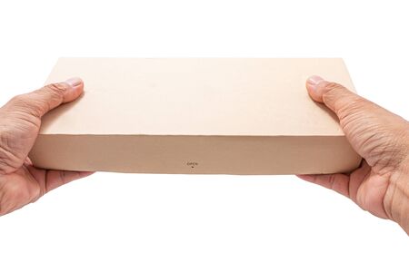 Hand holding cardboard box isolated on white background.