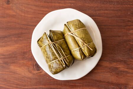 Dessert sticky rice or Khao Tom Mad, Khao Tom Pad, Wrapped the banana in sweet sticky rice and then wrapped them inside banana leaves. Top view.の写真素材