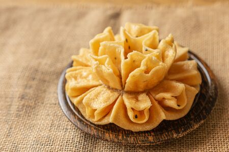 Crispy lotus blossom cookies isolated on white. Thai traditional snack. Top view. Thai homemade...