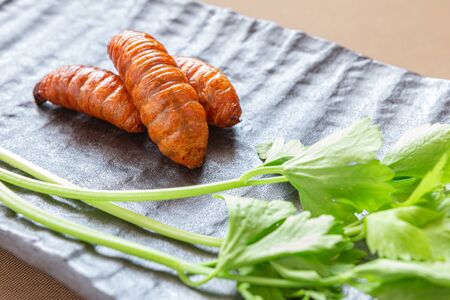 Insect food for fried Worm with vegetables in the brown plate. Healthy meal high protein diet...