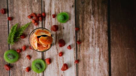Top view, Dried orange in a glass with dried kiwi slices, strawberry for  blurred background. Selective focusの写真素材