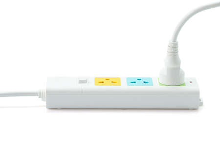 White plastic electrical multiple sockets with connected plugs on a white background.