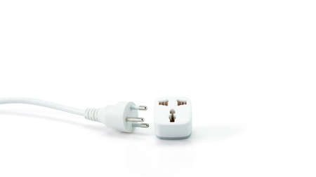 White plastic electrical multiple sockets with connected plugs on a white background.の写真素材