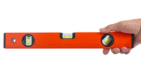 Hand holding spirit level tool for building isolated on white background with clipping path.