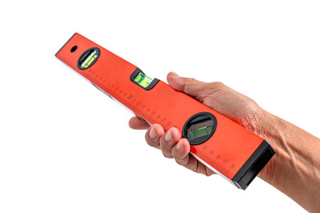 Hand holding spirit level tool for building isolated on white background
