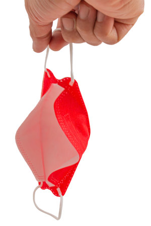 Hand holding red Medical masks to prevent disease, Coronavirus, Contaminated air, Flu, air pollution,  world pollutionの写真素材