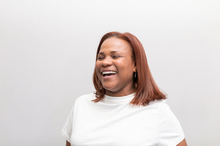 Portrait of a black woman client posing and smiling at the dental clinic hall