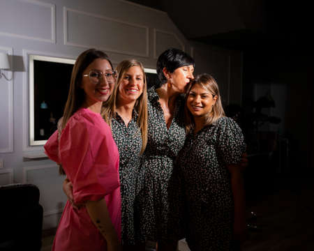 A group of a beauty and hair salon coworkers posing while hugging each other