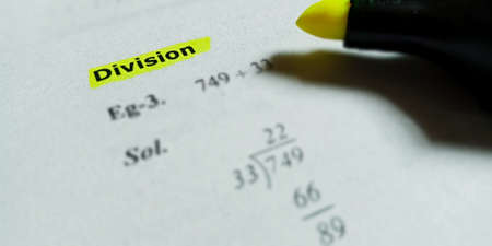 Division mathematical terminology presented on book text highlighted pattern on educational...