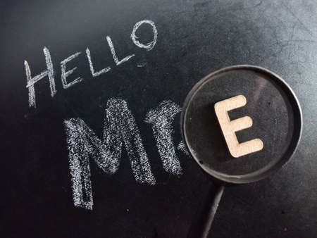 Hello mister E text displayed on chalk board concept with wooden alphabet english symbol.