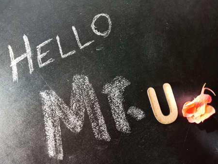 Hello mister U text displayed on chalk board concept with wooden alphabet english symbol.の写真素材