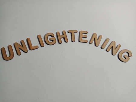 Unlightening latest vocabulary presented on white paper texture with wooden alphabets for modern communication pattern.の写真素材